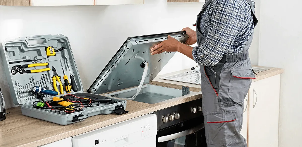 Handyman repairing a cooktop and checking wiring connections in Tulsa, OK