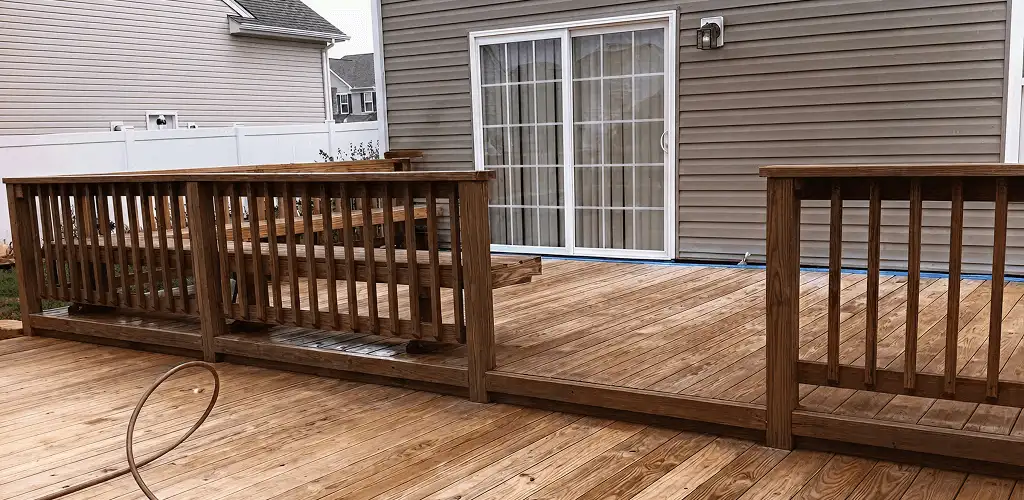 Deck sealing service protecting a backyard wood deck and railings in Tulsa, OK