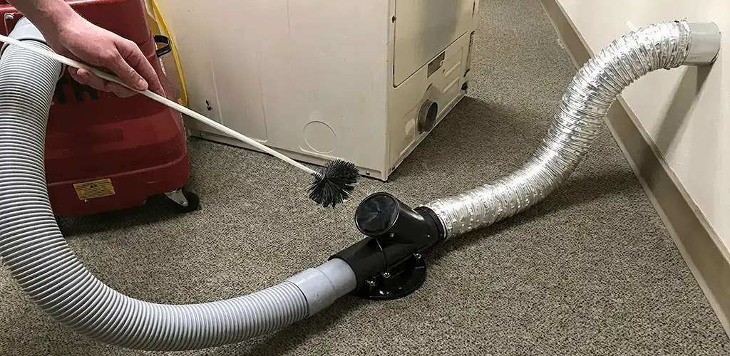 Dryer vent cleaning service removing lint from a dryer duct connection in Tulsa, OK
