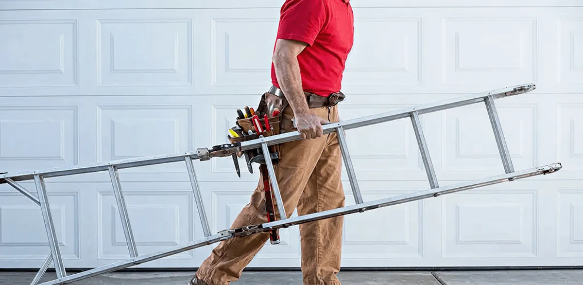 Garage door repair technician arriving with tools and ladder in Tulsa, OK