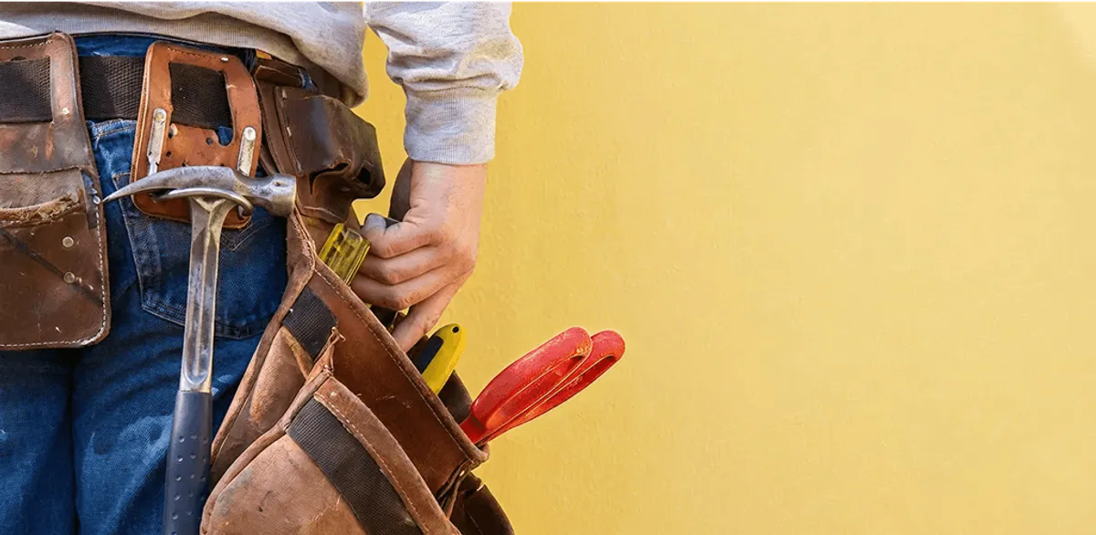 Handyman with tool belt ready for home repairs and maintenance in Tulsa, OK