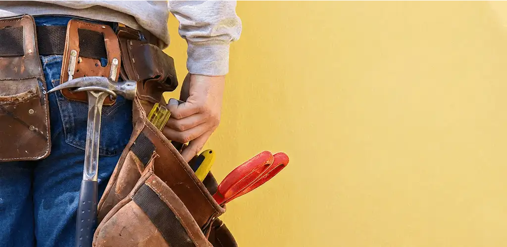 Handyman with tool belt ready for home repairs and maintenance in Tulsa, OK