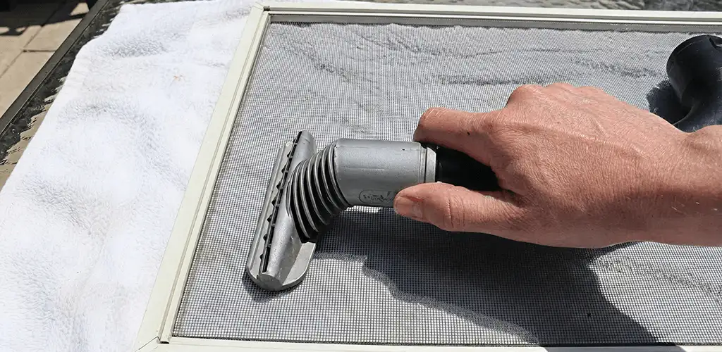 Window screen repair cleaning and fixing a damaged screen mesh in Tulsa, OK